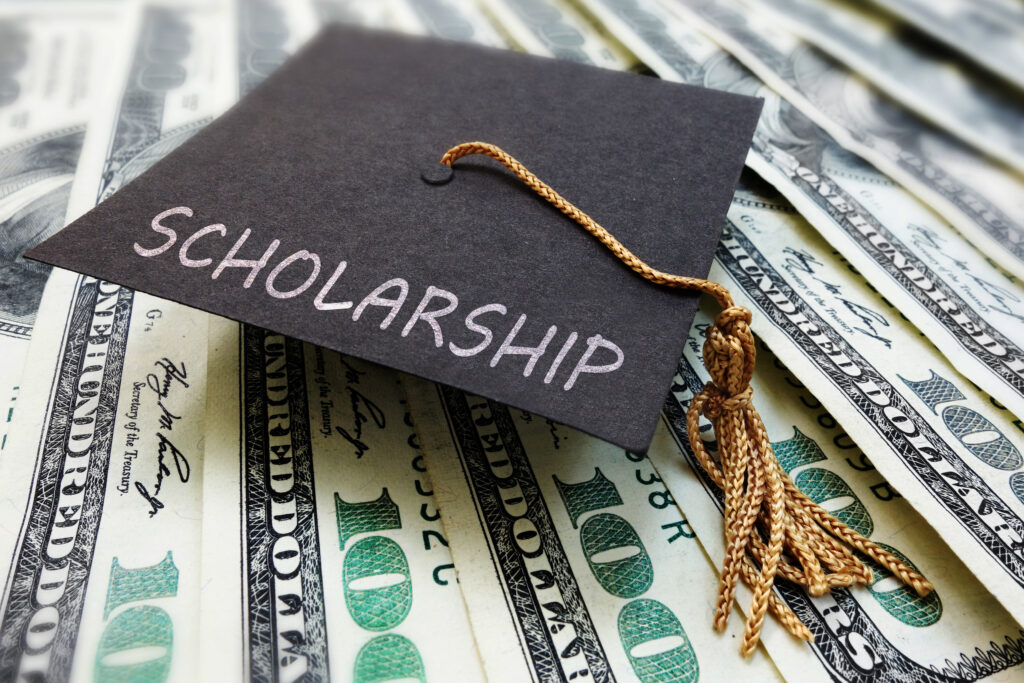 Scholarship money with a small graduation cap